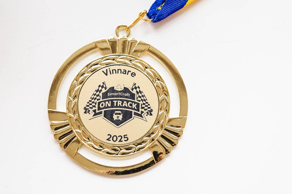 a gold medal with a blue and yellow ribbon