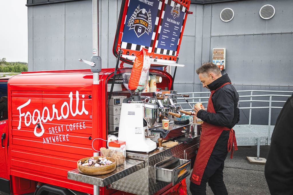 a man standing next to a coffee machine