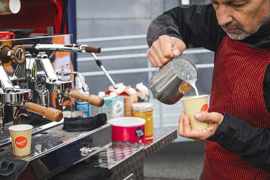 a man pouring milk into a cup