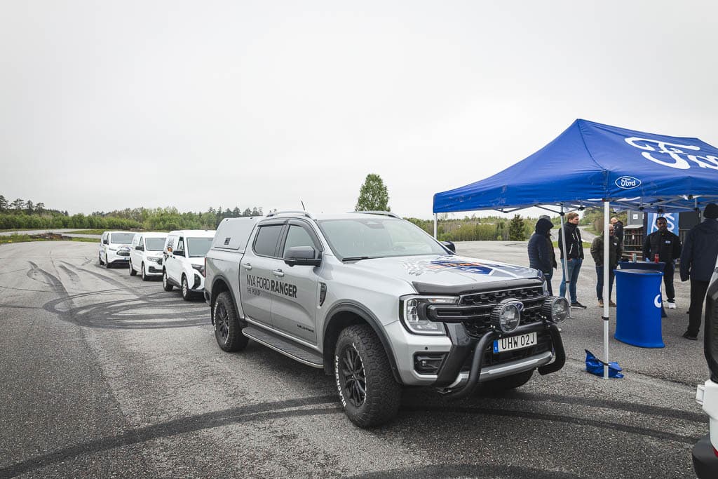 a group of people standing around a truck