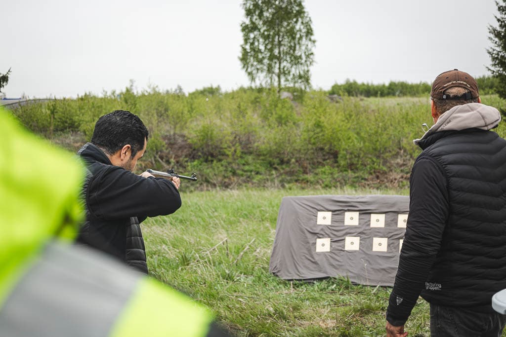 a group of men shooting with guns
