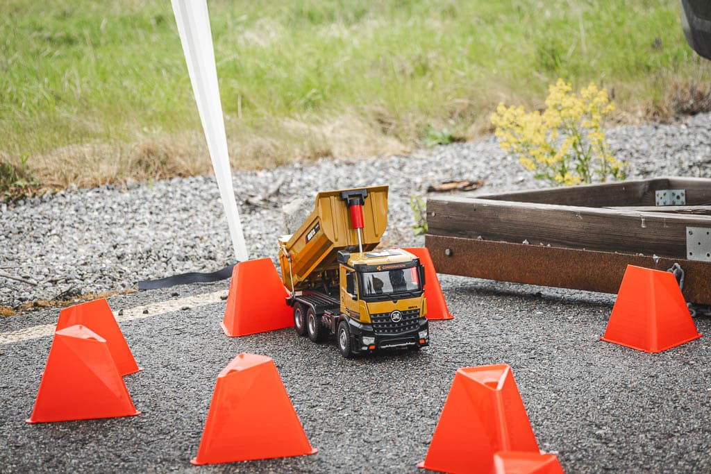 a toy truck with orange cones