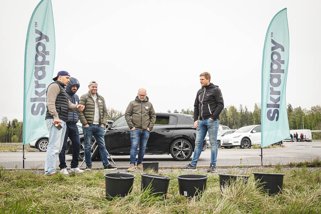 a group of men standing in front of buckets
