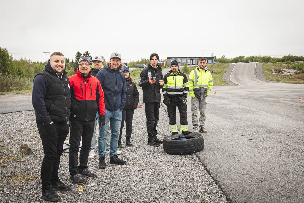 a group of men standing on a tire