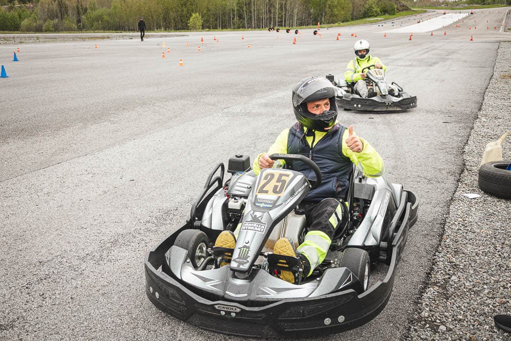 a group of people driving go karts