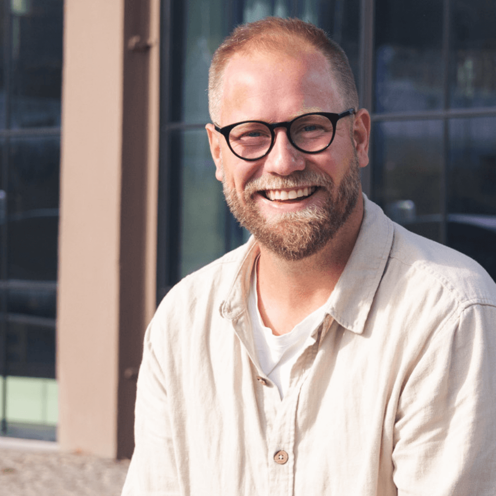 a man smiling at the camera